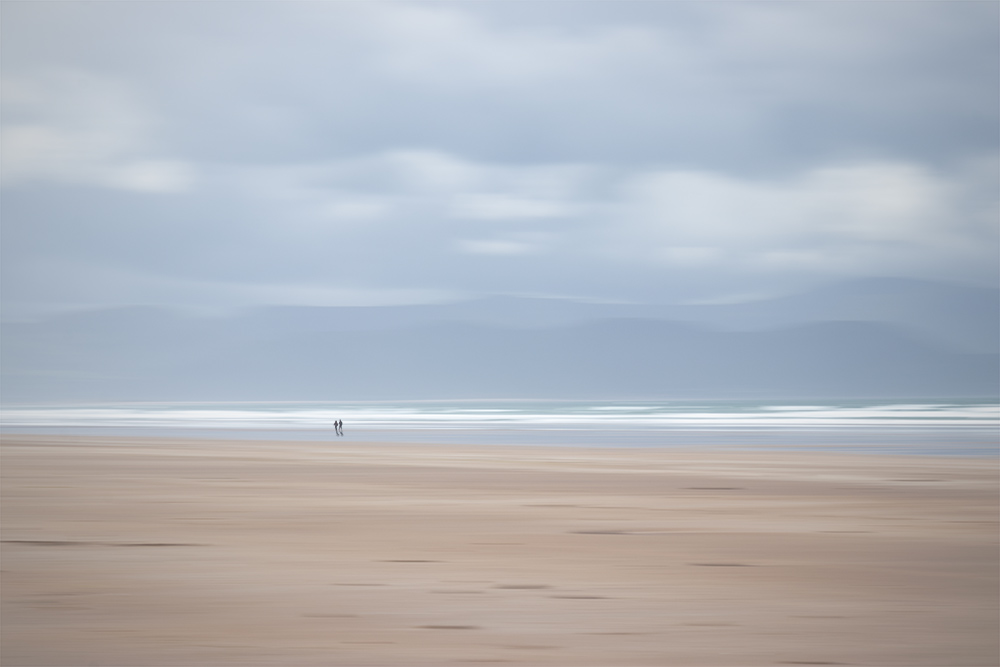 Horizontal panning is great for photos with strong horizons. This one is a combination of two shots - one using longer shutter speed and intentional camera movement for the environment. I took the second shot at "normal" shutter speed to capture the couple taking a walk. The result is an illusion of two people walking on an impressionist beach.