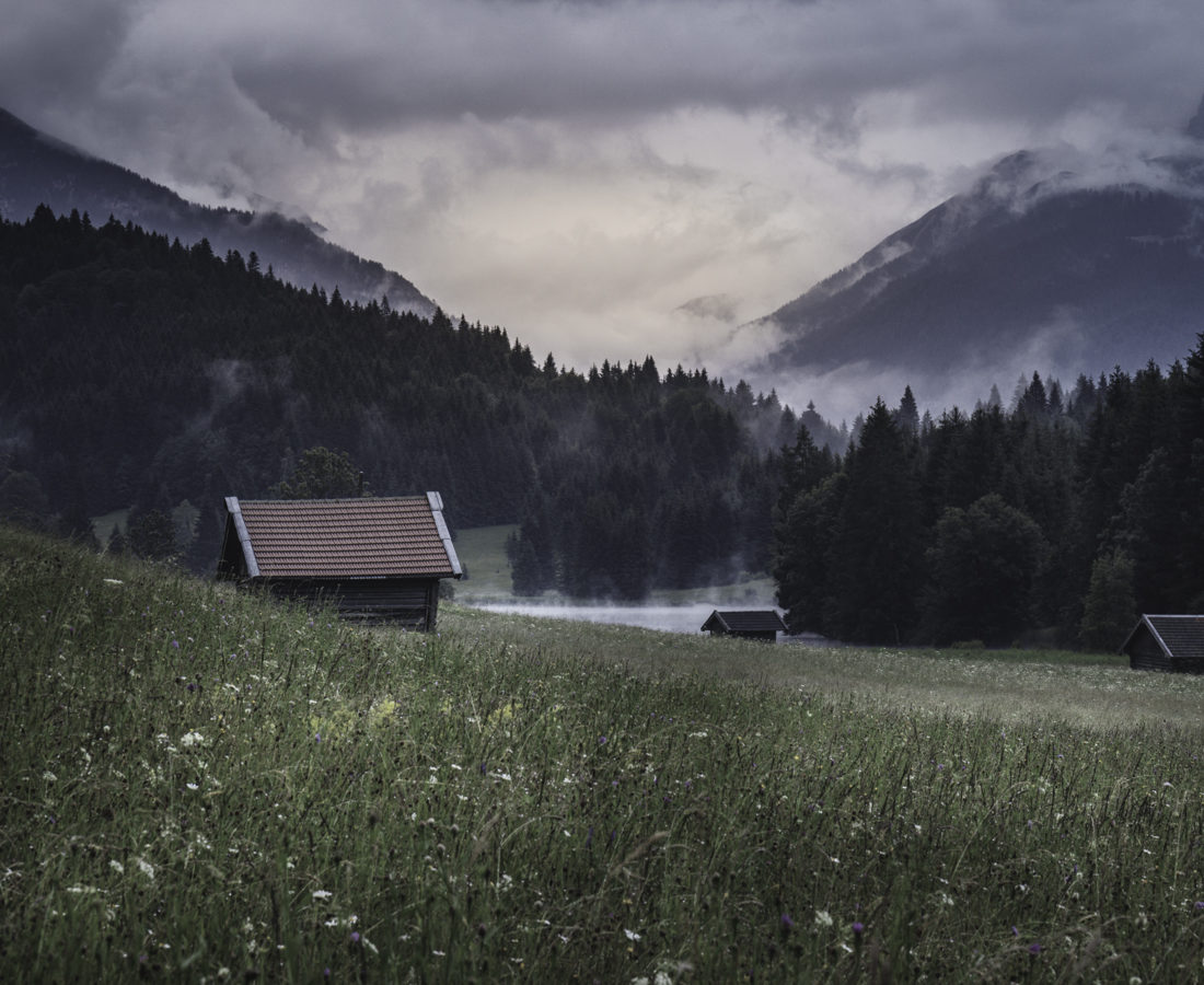 Another view of the Geroldsee Valley with alpine cabins scattered around the meadow (long lens)